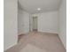 A bedroom with neutral-colored walls, carpet flooring, and view of a door leading to another room at 4142 Spring Valley Cir # 65, Tucker, GA 30084