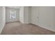 A neutral bedroom with carpet, a window overlooking the outside, and base trim at 4142 Spring Valley Cir # 65, Tucker, GA 30084