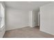 A neutral bedroom with carpet and white trim and walls with view into hallway at 4142 Spring Valley Cir # 65, Tucker, GA 30084