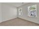 A bright bedroom with carpeted floor, white trim, windows letting in natural light at 4142 Spring Valley Cir # 65, Tucker, GA 30084