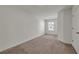 A bright bedroom featuring neutral paint, carpeted floors, and a window letting in natural light at 4142 Spring Valley Cir # 65, Tucker, GA 30084