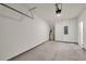 Large garage with painted concrete floor, hot water tank, and door leading to inside at 4142 Spring Valley Cir # 65, Tucker, GA 30084