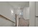 Upstairs hallway with wood railing, neutral carpet, and access to rooms at 4142 Spring Valley Cir # 65, Tucker, GA 30084