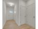 Bright hallway with wood-look floors, white walls, overhead lighting, and multiple entryways at 4142 Spring Valley Cir # 65, Tucker, GA 30084