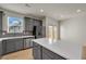 Grey kitchen with stainless steel appliances, large island with white countertop, and plenty of natural light at 4142 Spring Valley Cir # 65, Tucker, GA 30084