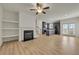 Open-concept living space with built-in shelving, a fireplace, and an eat-in kitchen at 4142 Spring Valley Cir # 65, Tucker, GA 30084