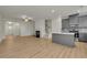 Open concept living space featuring wood-look floors, modern kitchen, staircase, and fireplace at 4142 Spring Valley Cir # 65, Tucker, GA 30084