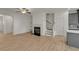Open-concept living space with wood-look floors, fireplace, staircase and modern kitchen at 4142 Spring Valley Cir # 65, Tucker, GA 30084