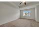 Carpeted main bedroom with ceiling fan and window with view to the backyard at 4142 Spring Valley Cir # 65, Tucker, GA 30084