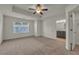 Spacious main bedroom with ensuite bath, plush carpet, ceiling fan, and large window at 4142 Spring Valley Cir # 65, Tucker, GA 30084