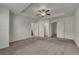 Main bedroom with ceiling fan, carpeted floors, a walk-in closet and ensuite bath at 4142 Spring Valley Cir # 65, Tucker, GA 30084