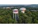 An elevated view showcasing the community water towers surrounded by lush greenery and glimpses of the city skyline at 546 Sawnee Village Blvd # D71, Cumming, GA 30040