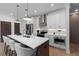 Modern kitchen with stainless steel appliances, an island with marble countertop and hanging lamps above it at 546 Sawnee Village Blvd # D71, Cumming, GA 30040