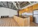 Bright, open kitchen with wood cabinets, stainless steel appliances, and a large island with a black countertop at 120 Ralph Mcgill Ne Blvd # 1304 & 1305, Atlanta, GA 30308