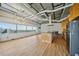 Spacious living area with light wood flooring, large windows showcasing city views, and a modern lighting fixture at 120 Ralph Mcgill Ne Blvd # 1304 & 1305, Atlanta, GA 30308