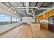 Open living space with a modern lighting fixture, light wood flooring, and large windows offering city views at 120 Ralph Mcgill Ne Blvd # 1304 & 1305, Atlanta, GA 30308