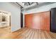 Bedroom with wood flooring, wall storage, and attached bathroom with classic accents at 120 Ralph Mcgill Ne Blvd # 1304 & 1305, Atlanta, GA 30308