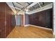 Open room with exposed ceilings, hardwood floors, and dark accent wall at 120 Ralph Mcgill Ne Blvd # 1304 & 1305, Atlanta, GA 30308