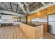 Open kitchen with a large island, wooden cabinets, stainless steel appliances, and modern design at 120 Ralph Mcgill Ne Blvd # 1304 & 1305, Atlanta, GA 30308