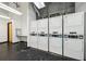 Community laundry room with multiple stacked washing machines and dryers at 120 Ralph Mcgill Ne Blvd # 1304 & 1305, Atlanta, GA 30308