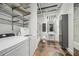 Laundry room featuring washer, dryer, overhead shelving and elegant bath fixtures at 120 Ralph Mcgill Ne Blvd # 1304 & 1305, Atlanta, GA 30308