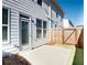 Back patio area with a wooden fence and an entrance door to the house, offering a private outdoor space at 1567 Aiden Way # 34, Conyers, GA 30013
