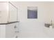 Bright bathroom showcasing a white tiled tub and shower, with minimalist decor and neutral accents at 1567 Aiden Way # 34, Conyers, GA 30013