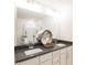 Bathroom with double vanity, gray countertops, decorative mirror, and a glass-enclosed shower at 1567 Aiden Way # 34, Conyers, GA 30013