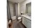 Well-lit bathroom featuring a shower-tub combo with modern fixtures and granite countertop sink at 1567 Aiden Way # 34, Conyers, GA 30013