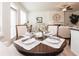 Cozy dining area featuring a round table set for four, adjacent to bright windows and an open living space at 1567 Aiden Way # 34, Conyers, GA 30013