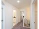 Hallway featuring carpet, white walls, a staircase and access to the bathroom and bedroom at 1567 Aiden Way # 34, Conyers, GA 30013
