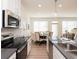 Modern kitchen features stainless steel appliances, sleek countertops, and a dining area with plenty of natural light at 1567 Aiden Way # 34, Conyers, GA 30013