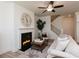 Charming living room showcases a cozy fireplace, stylish decor, and access to the staircase and other living areas at 1567 Aiden Way # 34, Conyers, GA 30013