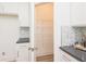 Well-organized walk-in pantry with wire shelving and white cabinets for storing food and kitchen essentials at 1567 Aiden Way # 34, Conyers, GA 30013