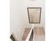 A view from the upper level of the staircase highlighting the modern wooden steps and nautical map at 1567 Aiden Way # 34, Conyers, GA 30013