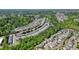 A scenic aerial view of the community features lush green landscaping, winding roads, and a collection of charming homes at 526 Lost Creek Dr, Woodstock, GA 30188