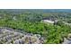 Aerial view showcases a residential area with a community pool and playground near a school and surrounded by trees at 526 Lost Creek Dr, Woodstock, GA 30188
