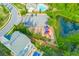 Aerial view showcases a playground, parking area, and a serene pond near well-maintained homes at 526 Lost Creek Dr, Woodstock, GA 30188