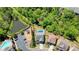 Aerial view displays a home with a private pool, playground, adjacent pond, and parking area at 526 Lost Creek Dr, Woodstock, GA 30188