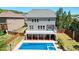 Backyard features a pool with a deck, lush grass, and a well-maintained fence for privacy at 526 Lost Creek Dr, Woodstock, GA 30188