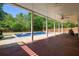 Inviting backyard featuring a sparkling blue swimming pool and a covered patio area with ceiling fans at 526 Lost Creek Dr, Woodstock, GA 30188