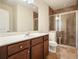 Bathroom featuring a glass-enclosed shower with custom tile work and a wooden vanity with white countertop at 526 Lost Creek Dr, Woodstock, GA 30188