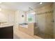 Bright bathroom features a modern shower, a large tub, and and vanity sinks at 526 Lost Creek Dr, Woodstock, GA 30188