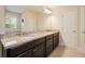 Bathroom with granite countertop, double sinks, dark wood cabinets and neutral walls at 526 Lost Creek Dr, Woodstock, GA 30188