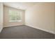 An empty bedroom with neutral carpet, a window, and freshly painted walls at 526 Lost Creek Dr, Woodstock, GA 30188
