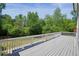 Overlooking a mature tree canopy, the large deck features secure railings at 526 Lost Creek Dr, Woodstock, GA 30188