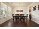 Bright dining room with a large window, chandelier, and dark wood dining table at 526 Lost Creek Dr, Woodstock, GA 30188