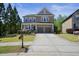 Charming two-story home with stone and siding, with a long drive way and covered porch at 526 Lost Creek Dr, Woodstock, GA 30188