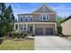 Charming two-story home with stone and siding, and a welcoming front porch at 526 Lost Creek Dr, Woodstock, GA 30188