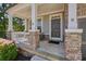 Cozy front porch with stone columns and railing, providing a relaxing space to enjoy the outdoors at 526 Lost Creek Dr, Woodstock, GA 30188